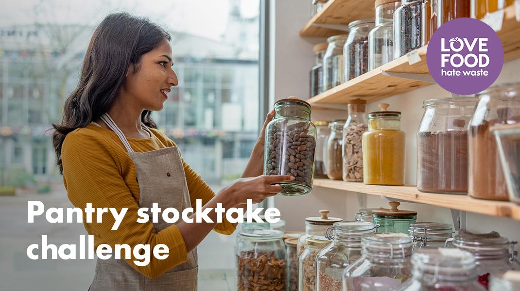 woman checking glass jars in a pantry